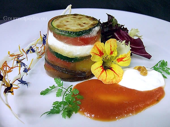 Timbale of grilled vegetables in jelly with tomatoes and sour cream sauce