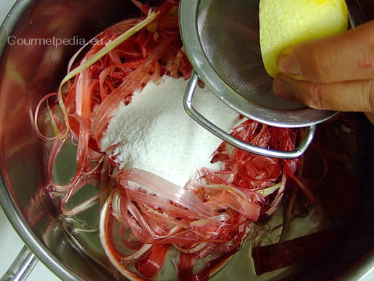 Die Schalen mit Zucker und Zitronensaft in einem Topf in etwas Wasser zum Kochen bringen