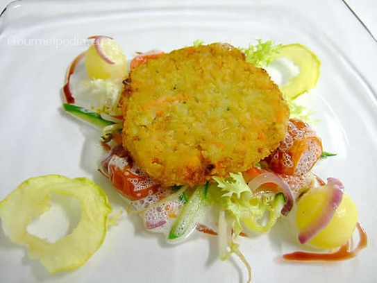 Fried vegetable escalope on vegetables in cheese sauce