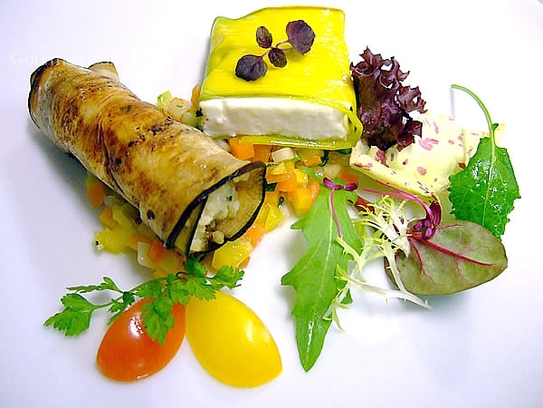 Variation of eggplant rolls stuffedwith couscous and parcels of leek and goat cheese