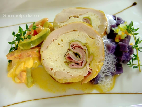 Guinea hen roll filled with ham and leek on creamed pepper vegetables and sauteed blue potatoes