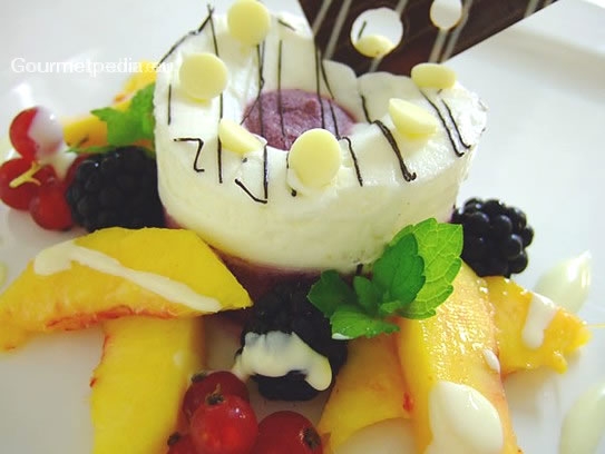 Blueberry and vanilla mousse on marinated peaches and wild berries