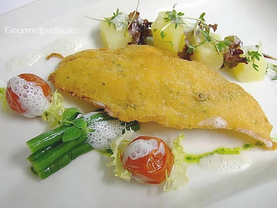 Fried fish fillet in green olive bread crust