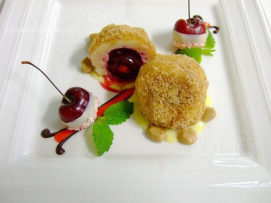 Cherry dumplings of cottage cheese with nougat on vanilla sauce