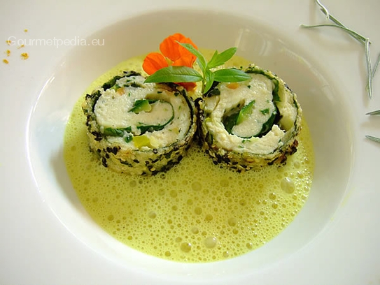 Cream of curry soup with fried chicken roulades in sesame
