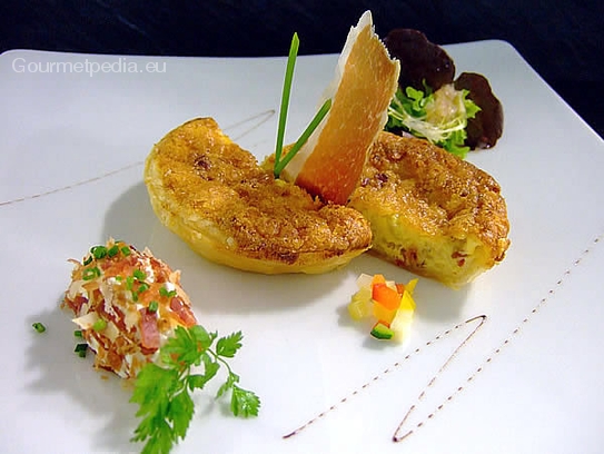 Quiche Lorraine with sour cream and bacon quenelle on marinated salads