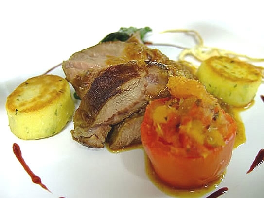 Braised veal cheek with stuffed tomato and potato cakes