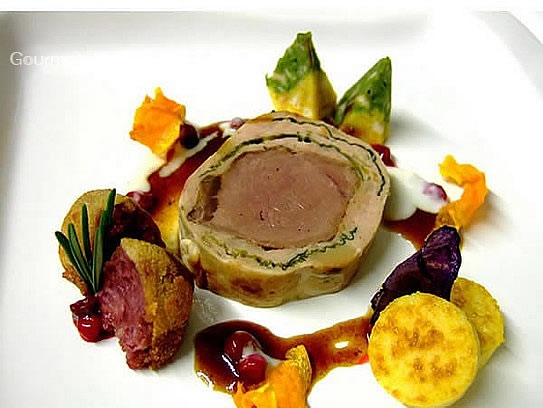 Médaillon of cerf in yellow boletus mushrooms and Savoy cabbage on cranberry sauce