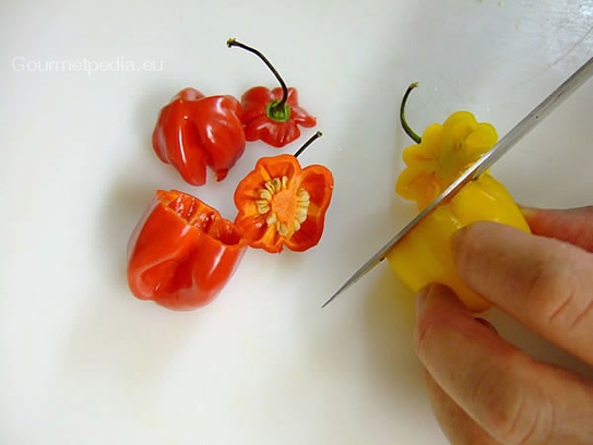 Die scharfen Mini-Paprika waschen und den Deckel abschneiden