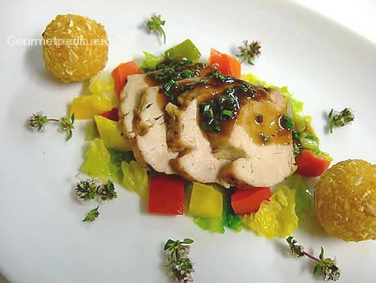 Pork tenderloin in chive sauce served with vegetables and croquette potatoes