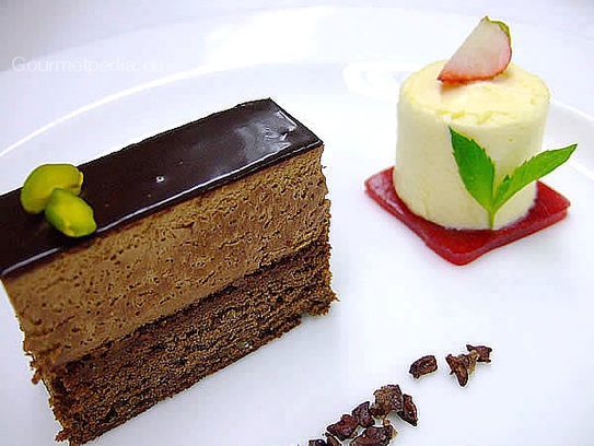 Corte de tarta au chocolate con semifrío de lima sobre jalea de frambuesa