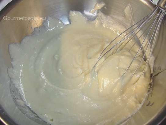 Den heißen Zuckersirup mit dem Honig vermischen und den Eischnee einrühren