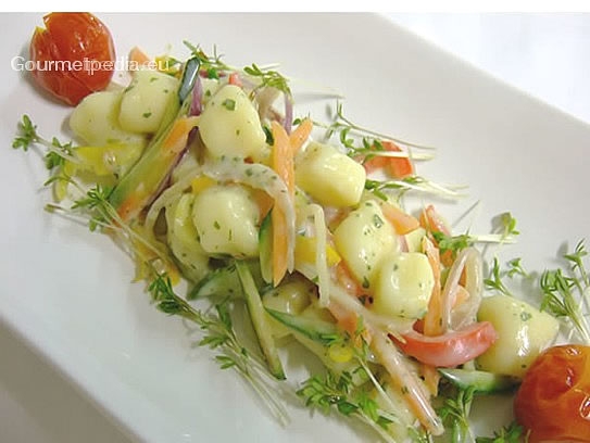 Potato gnocchi with vegetables and parsley sauce