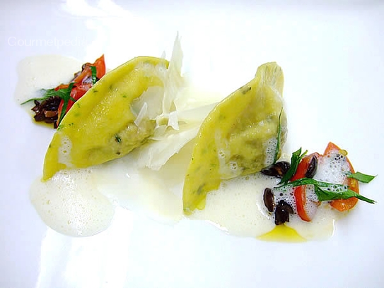 Herbs ravioli filled with ratatouille vegetables on sauteed olive tomatoes, truffled oil and parmesan foam