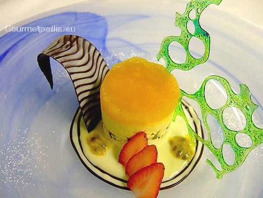Passion fruit parfait with pistachio and plain chocolate on white chocolate sauce
