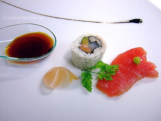 Variety of sashimi and sushi roll with marinated ginger and soy sauce