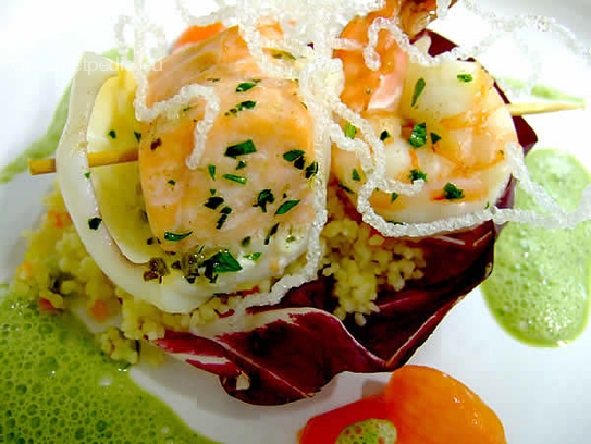 Brochette of seafish on aromatic vegetables couscous with basil sauce