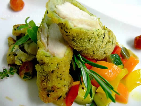 Fried fillet of rabbit in a bread crust on peppers vegetables