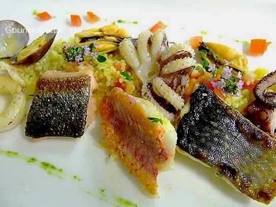 Variety of pan-seared seafish on vegetables couscous