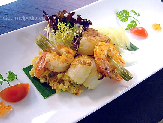 Skewered king prawns and scallops on vegetables couscous with stewed white balsamic onions