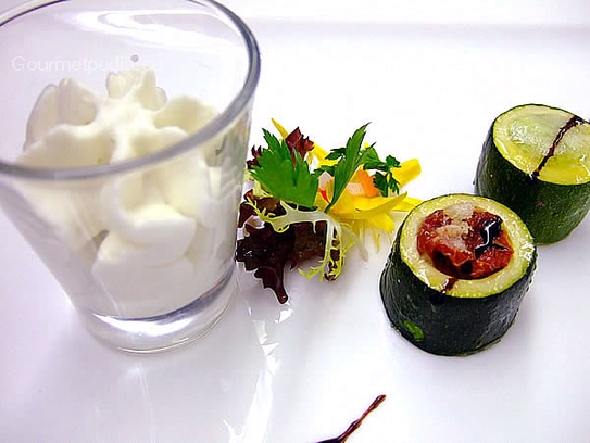 Stuffed courgettes with tomato stew and courgettes cream on parmesan foam