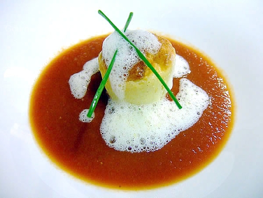 Cream of tomato soup with poached cheese pudding and parmesan foam