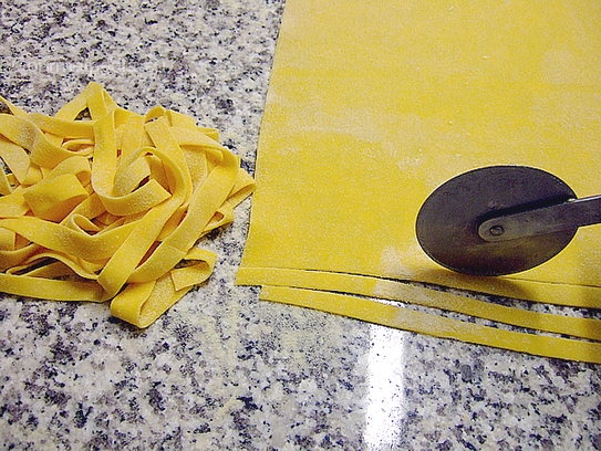 Für die Tagliatelle den ausgerollten Teig mit dem Teigrad in ca.0.5cm breite Streifen schneiden