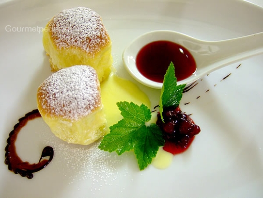 Brioche squares austrian style with vanilla sauce and cranberry jam