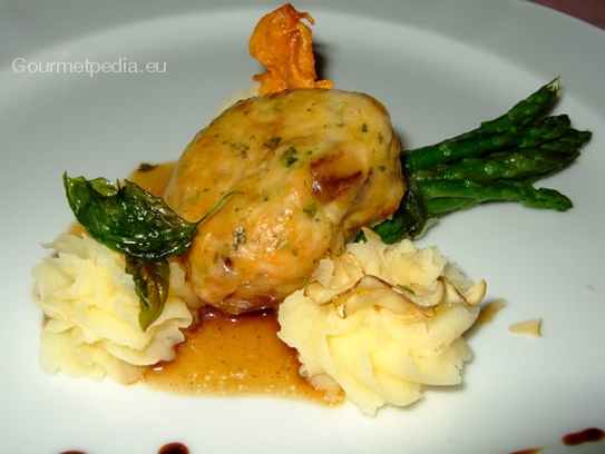 Fillet of veal in yellow boletus mushrooms on mashed potatoes and green asparagus