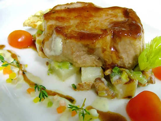 Veal steak on potato and leek vegetables with chanterelles