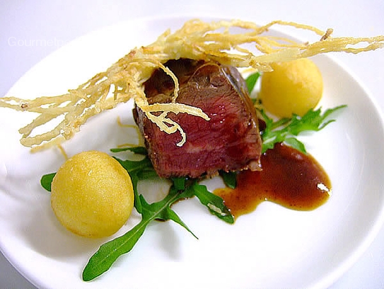 Mignon of beef fillet on rocket and potato pearls