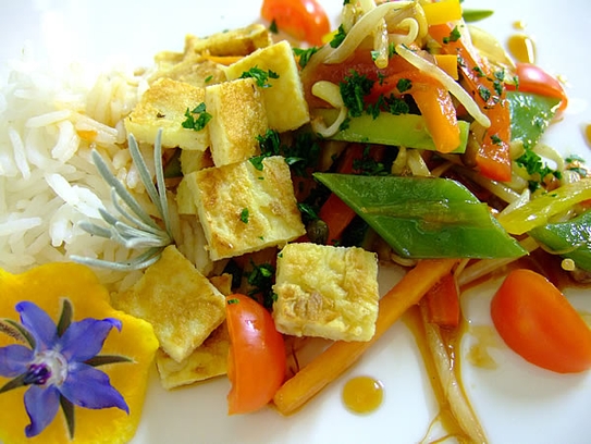 Vegetables and soy-bean sprouts stir-fried in the wok with jasmin rice and pan-seared omelette
