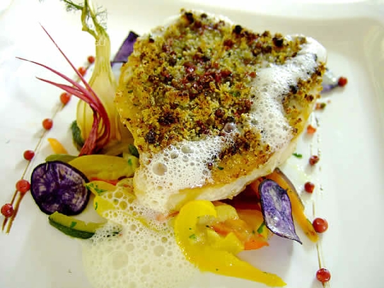 Steak of swordfish in a red pepper crust on sauteed vegetables
