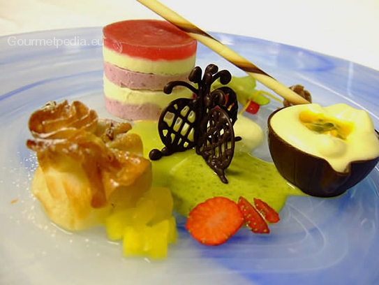Sachet of strudel pastry with pineapple and blackcurrant parfait with passion fruit mousse in a chocolate cup