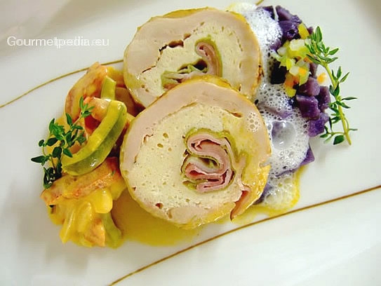 Guinea hen roll filled with ham and leek on creamed pepper vegetables and sauteed blue potatoes