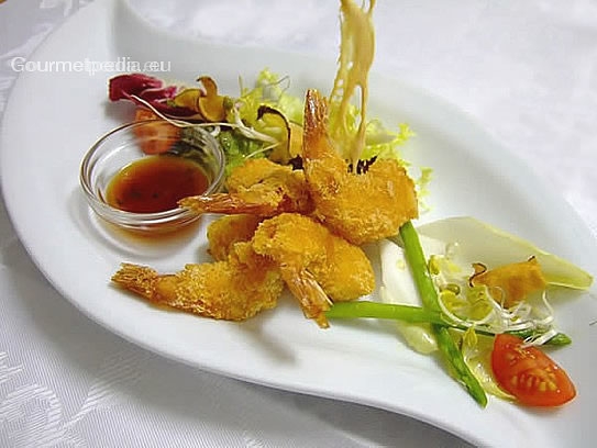 Fried shrimps on salads with a sweet-and-sour sauce