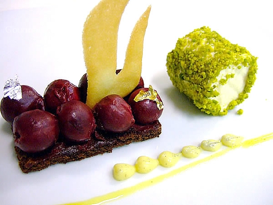 Chocolate sponge cake with pistachio marzipan, sour cherries and white chocolate parfait