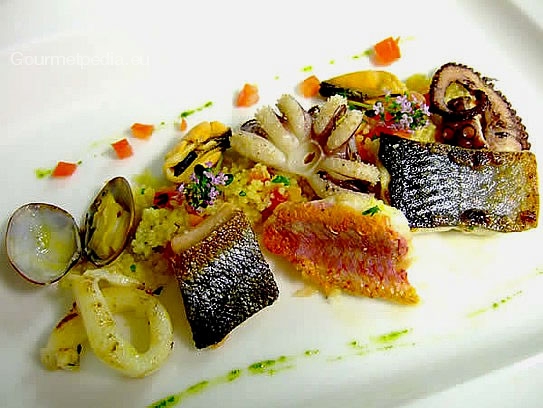 Variety of pan-seared seafish on vegetables couscous